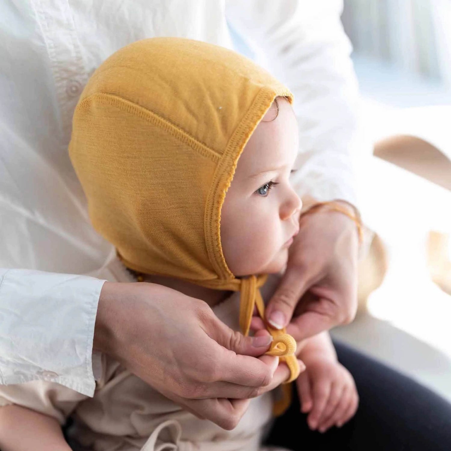 Baby hat made of merino wool in ocher