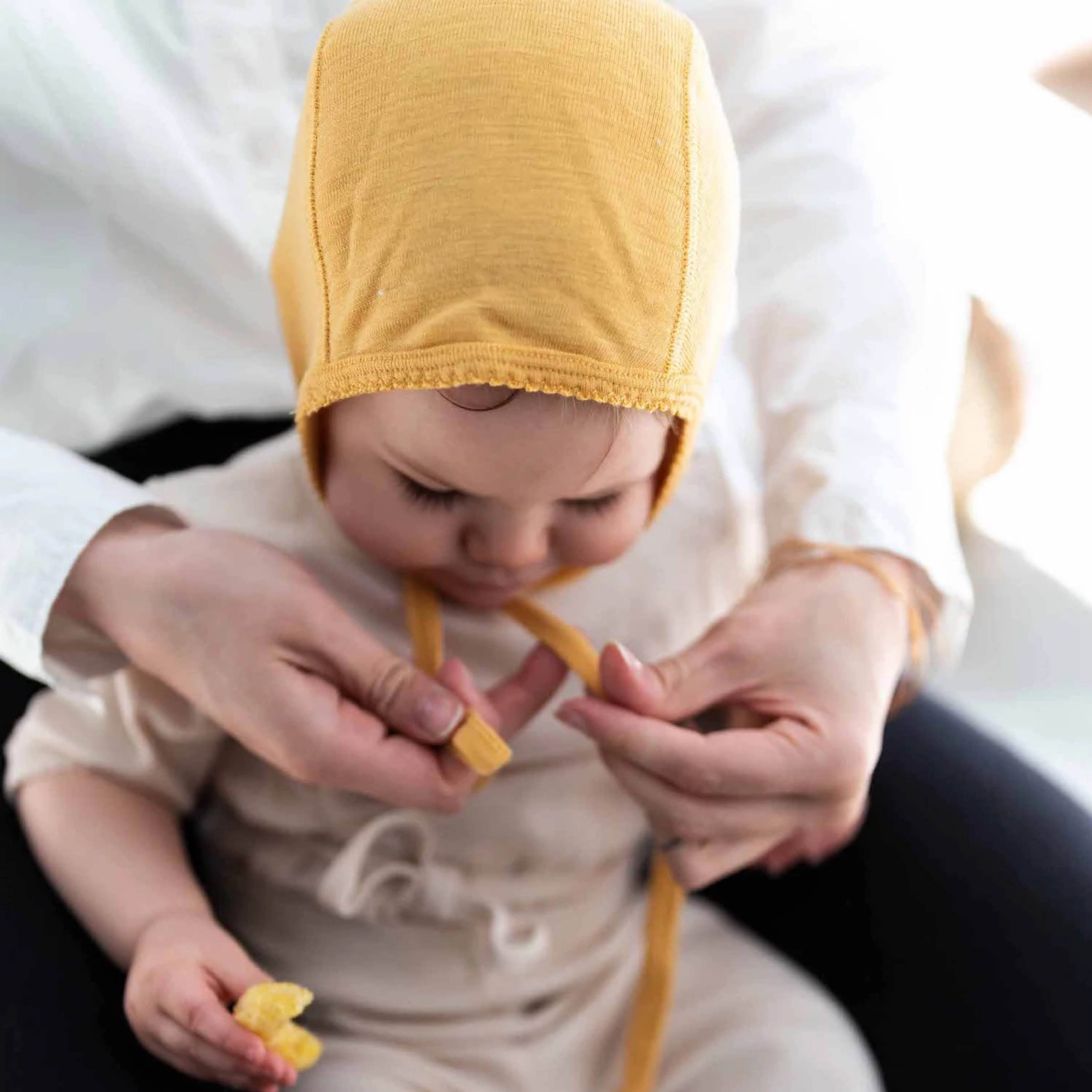 Baby hat made of merino wool in ocher